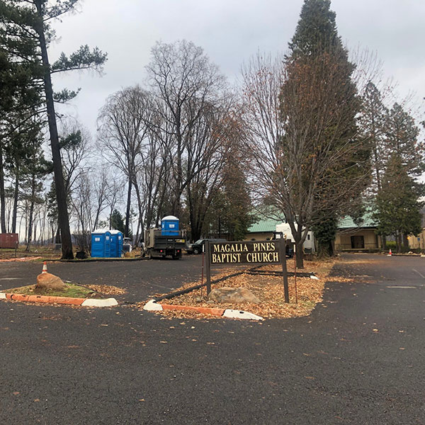 blue portable toilets in church parking lot in Magalia, CA
