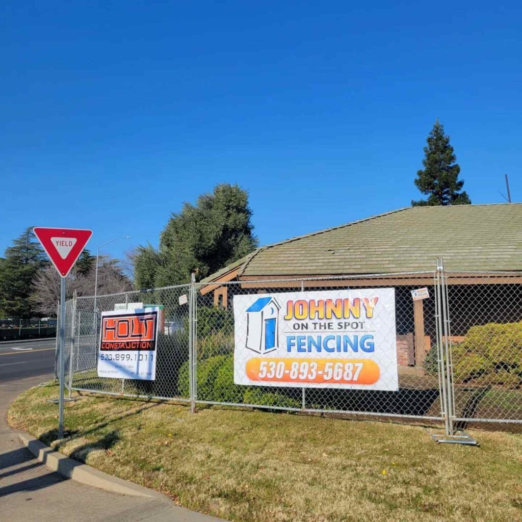 fence with banner that reads johnny on the spot fencing