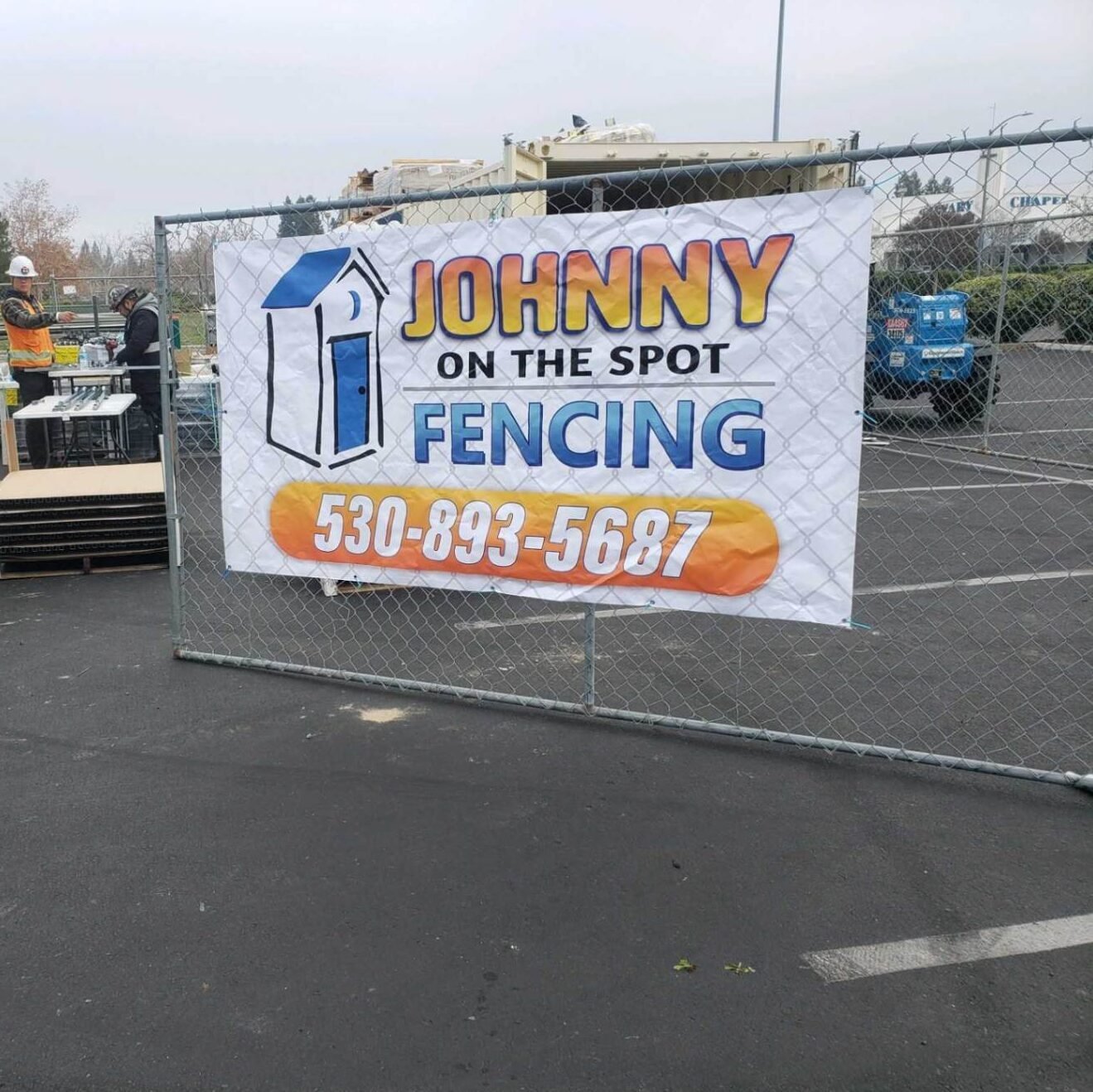 fence with banner that reads johnny on the spot fencing